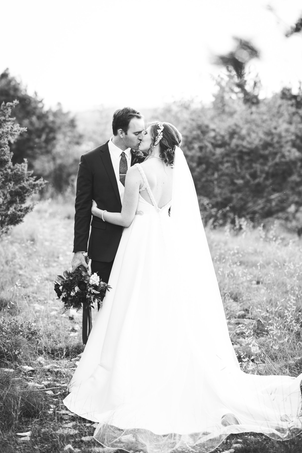 terrace club wedding photographer romantic kiss bride groom natural light 2600 US-290, Dripping Springs, TX 78620