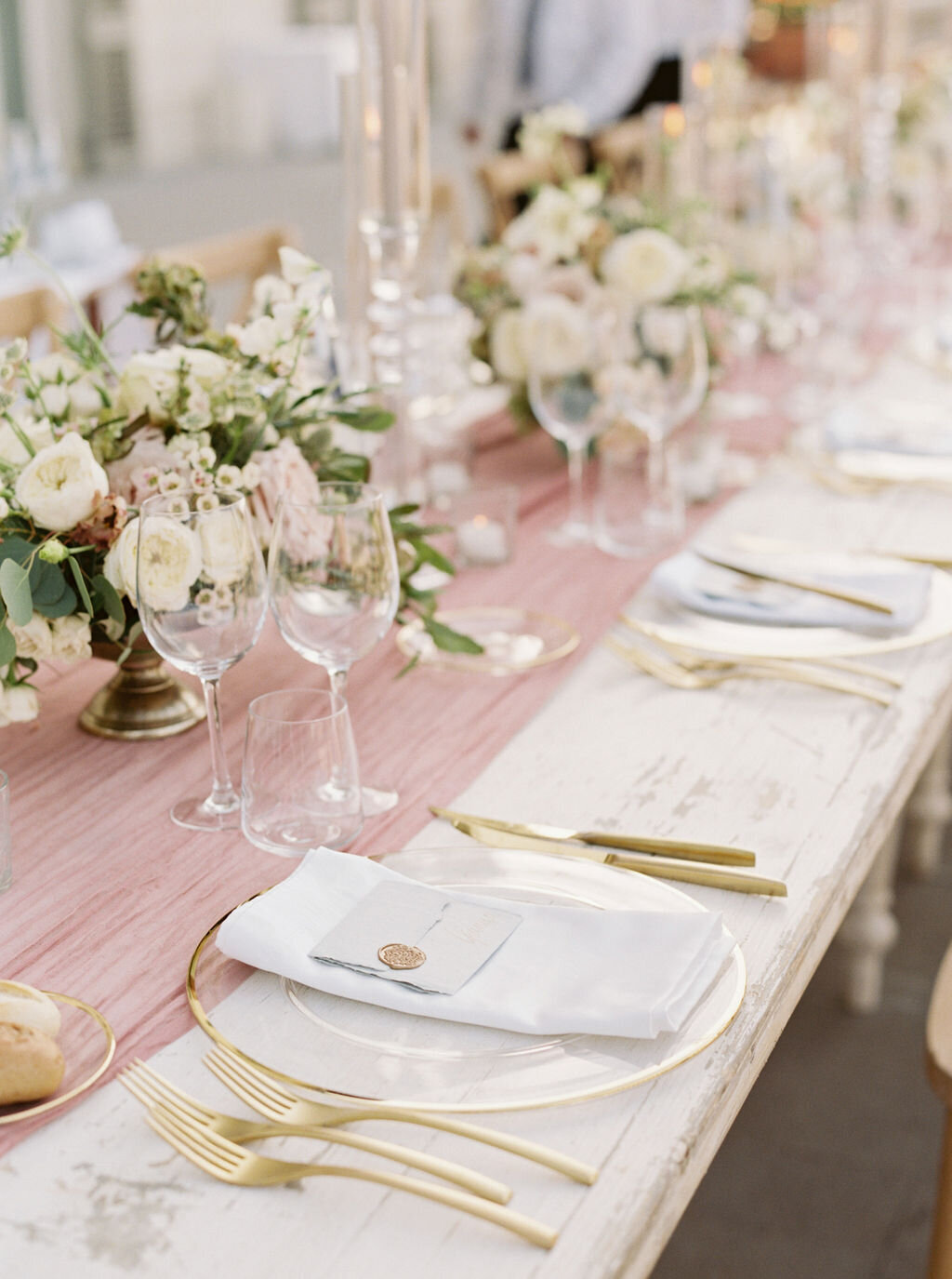 Gold placesettings on a long wedding table
