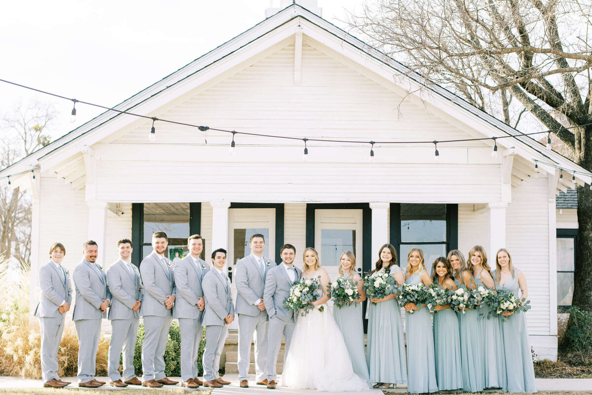 Wedding party stands outside at January wedding in Denton, Texas