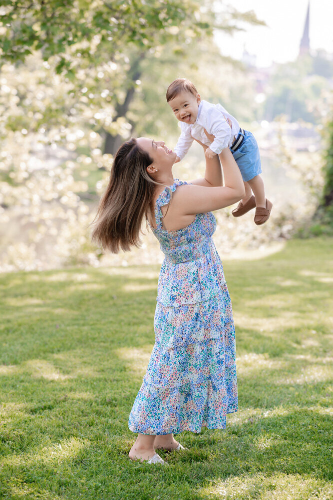 Family session of little boy with mother wearing a floral dress