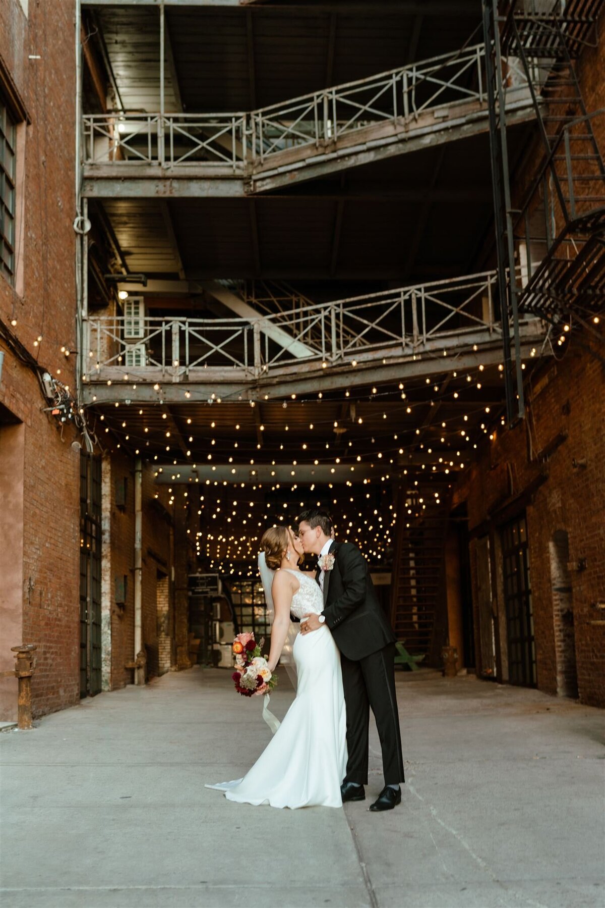 couples photos of bride and groom under twinkle lights