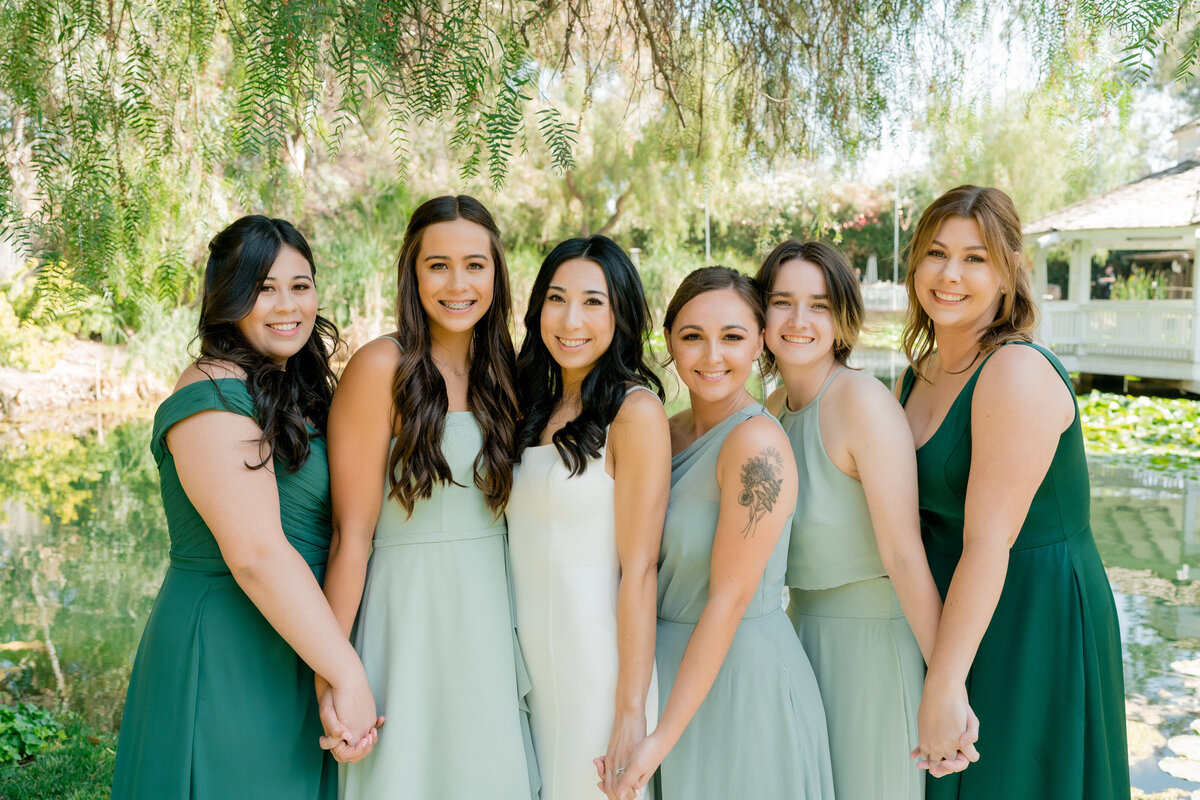 group photo of women in green and white dresses