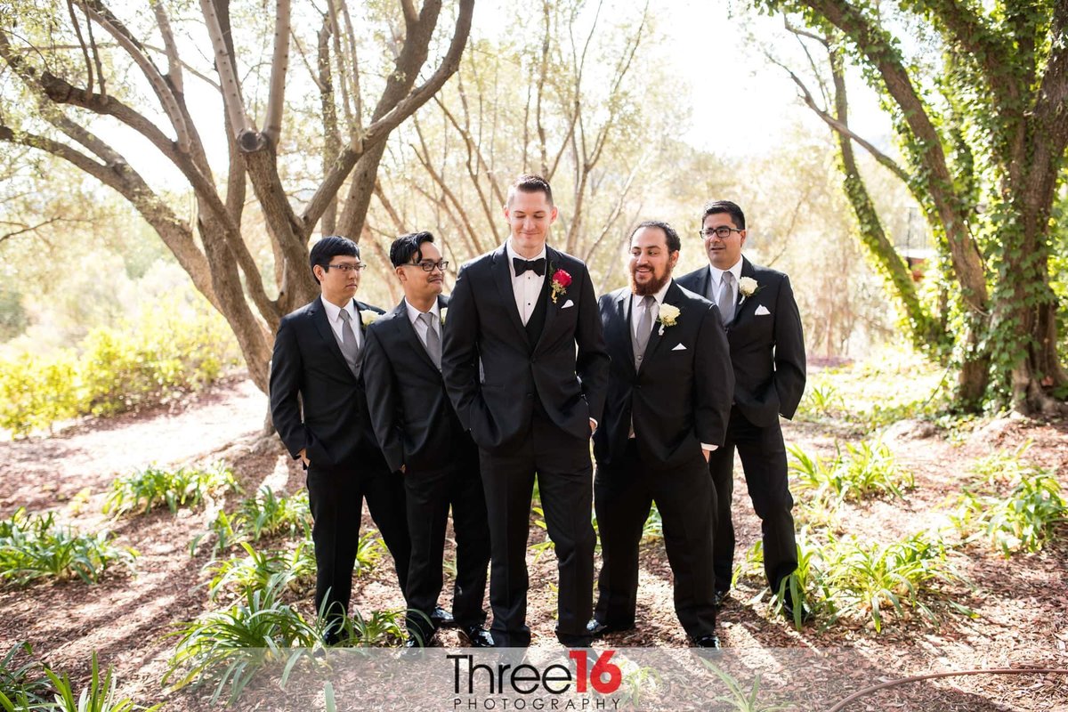 Groom surrounded by his groomsmen