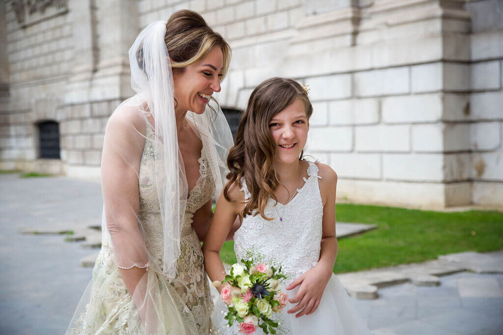 Bride laughing with young daughter outside St Pauls