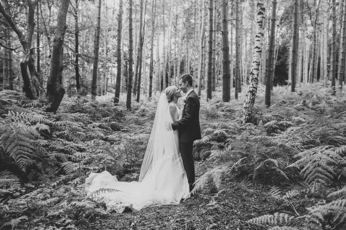 couple kissing in the woods at peckforton castle