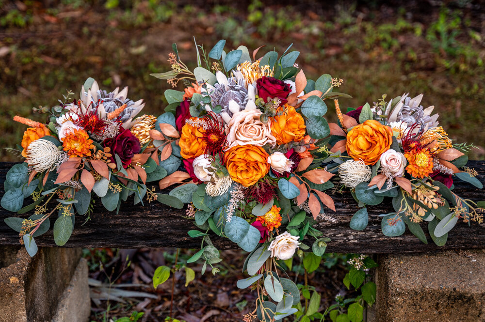 bride and bride maids bouquets on a bench - Townsville Wedding Photography by Jamie Simmons