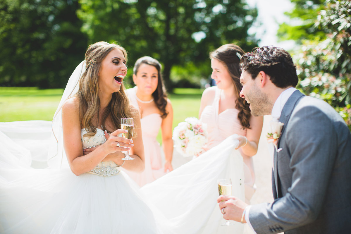 bride and groom laughing with friends