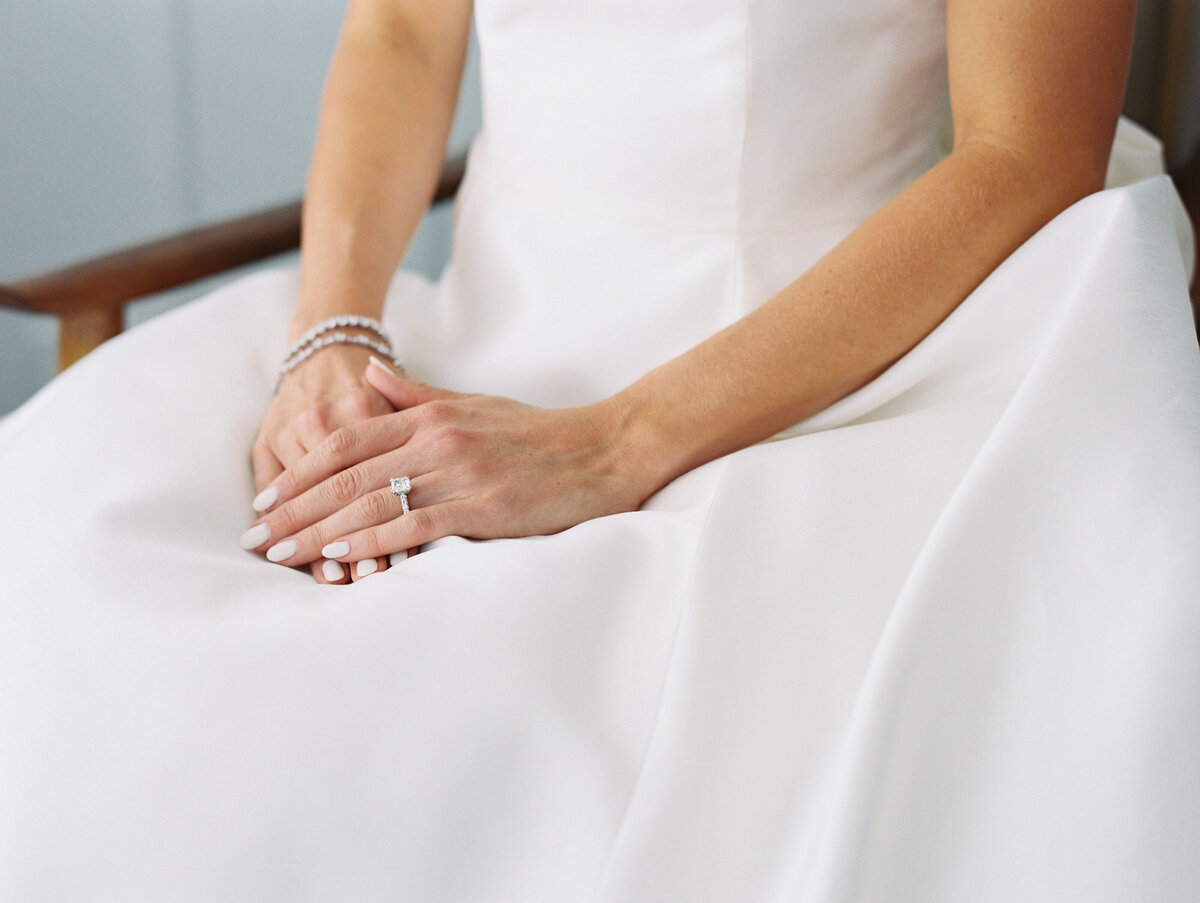 Bride sitting with hands rested on each other