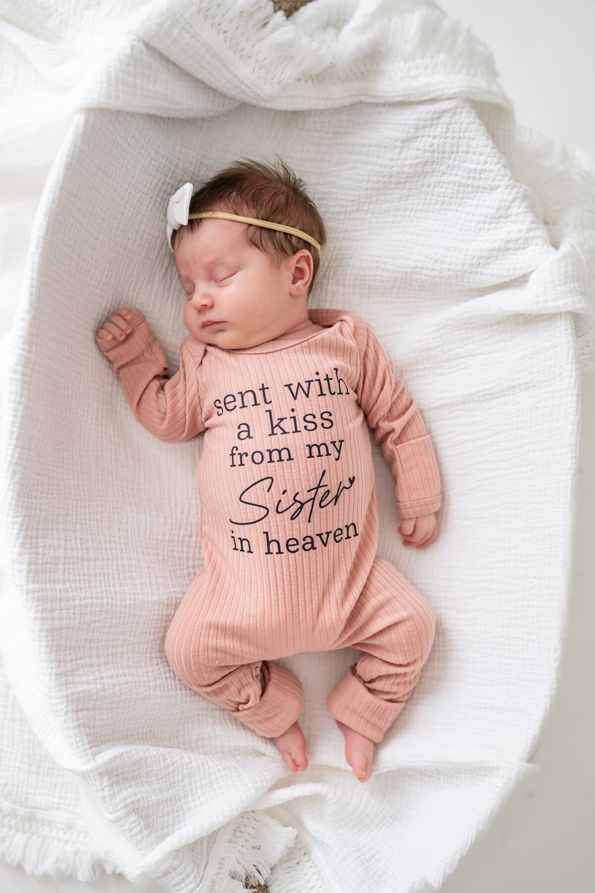 A newborn baby sleeping in a bassinet 