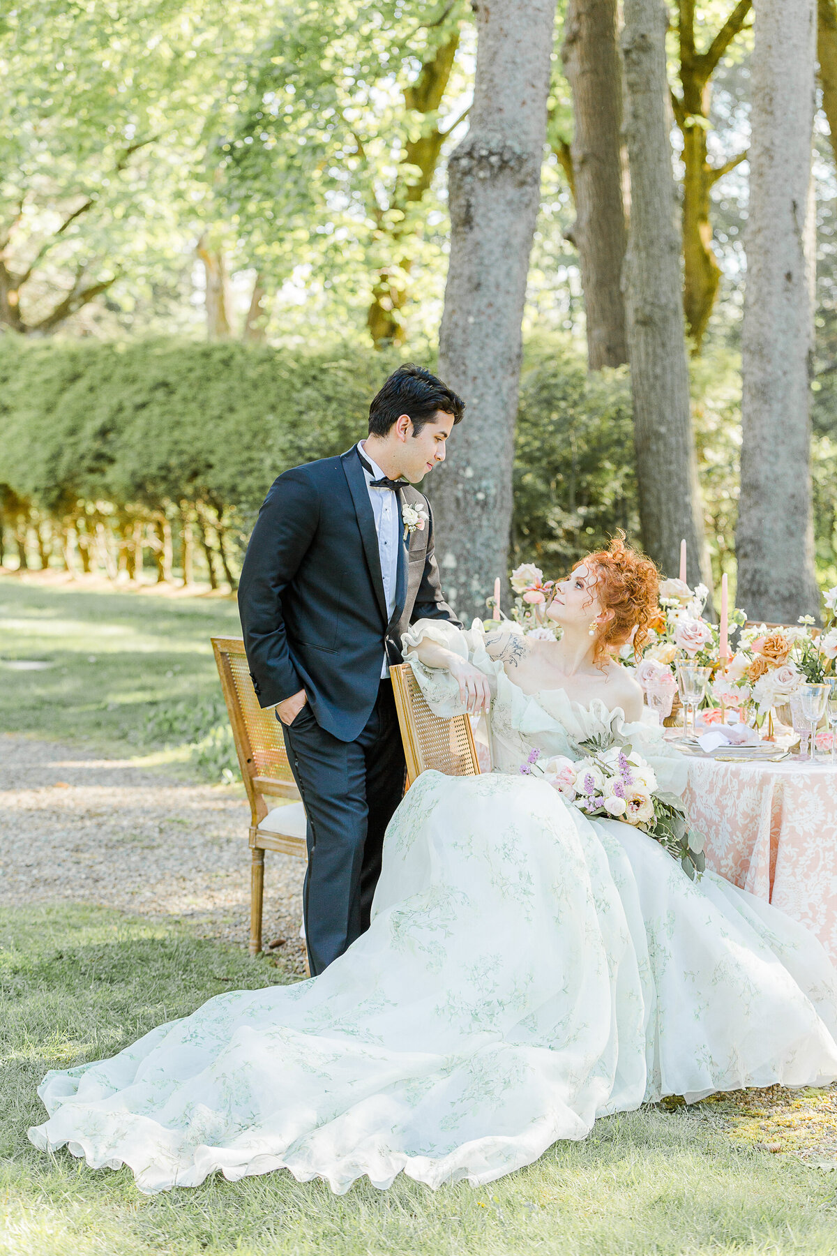 Bride and groom share a glance at their North Shore Boston outdoor wedding reception. Captured by best Massachusetts wedding photographer Lia Rose Weddings