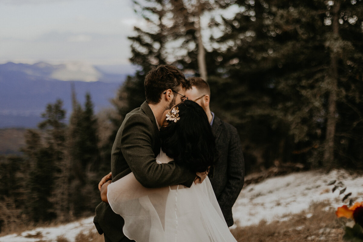 bride and grooms first kiss on Sandia Mountain after their elopement