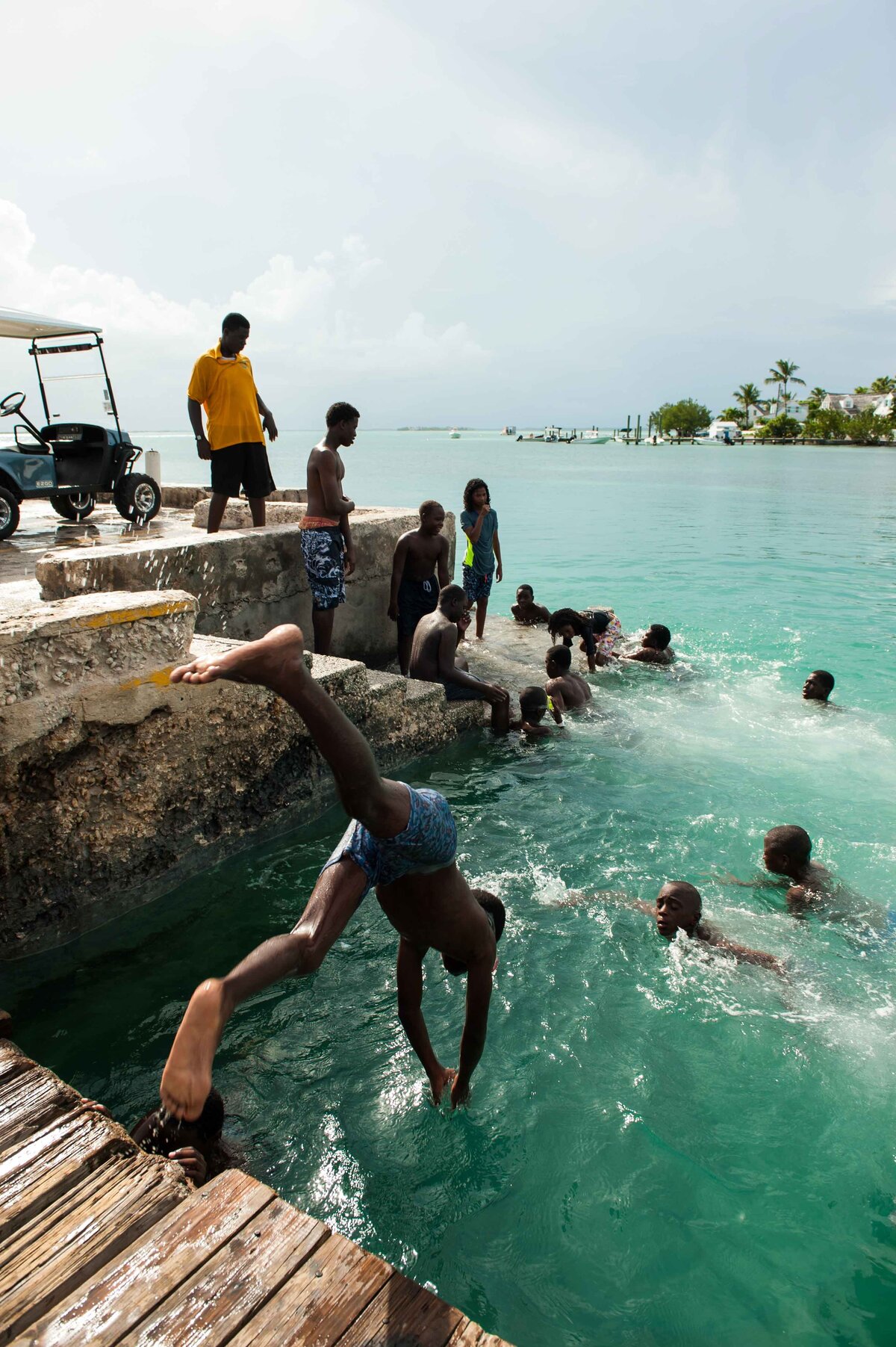 Children dive off a dock on Harbour Island Bahamas