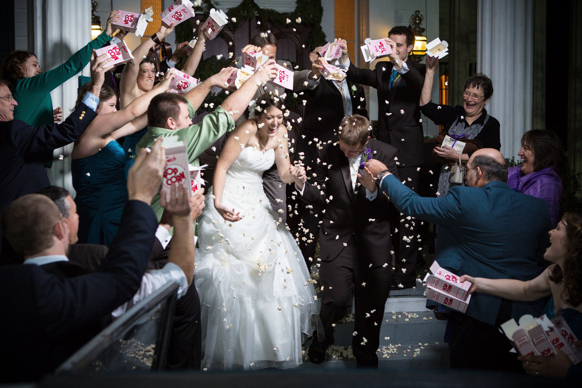 A couple gets showered with Popcorn as they leave their wedding reception at The Bragg-Mitchell Mansion in Mobile, Alabama.