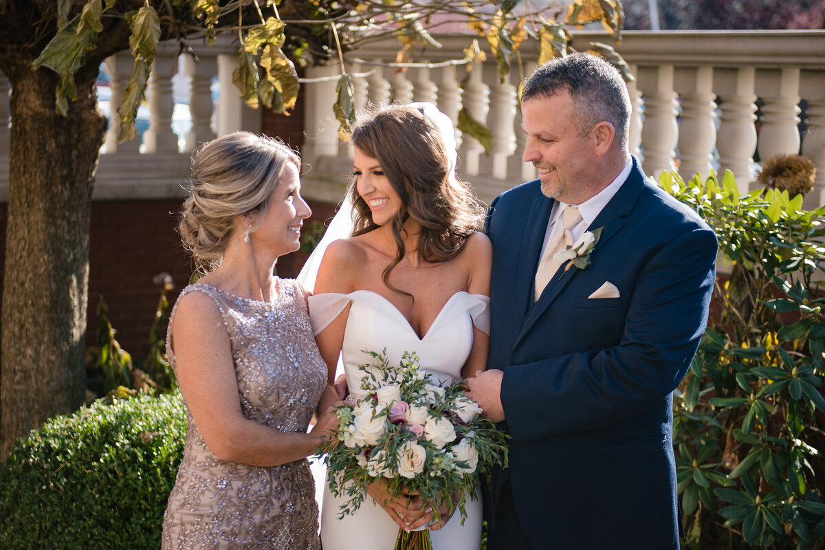 bride with parents smiling