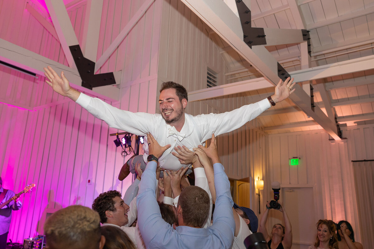 groom is lifted in crowd surf at wedding reception Milestone Georgetown