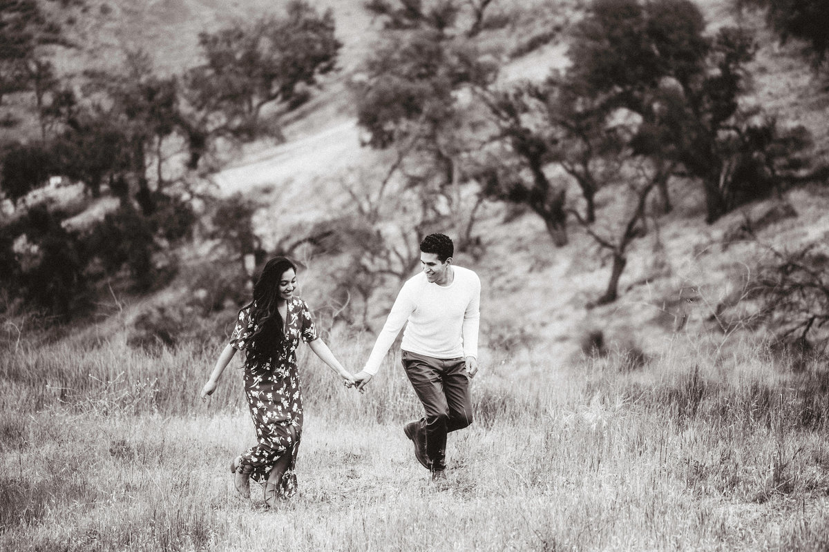 Engagement Photograph Of  Man And Woman Holding Hands While Walking Black And White Los Angeles