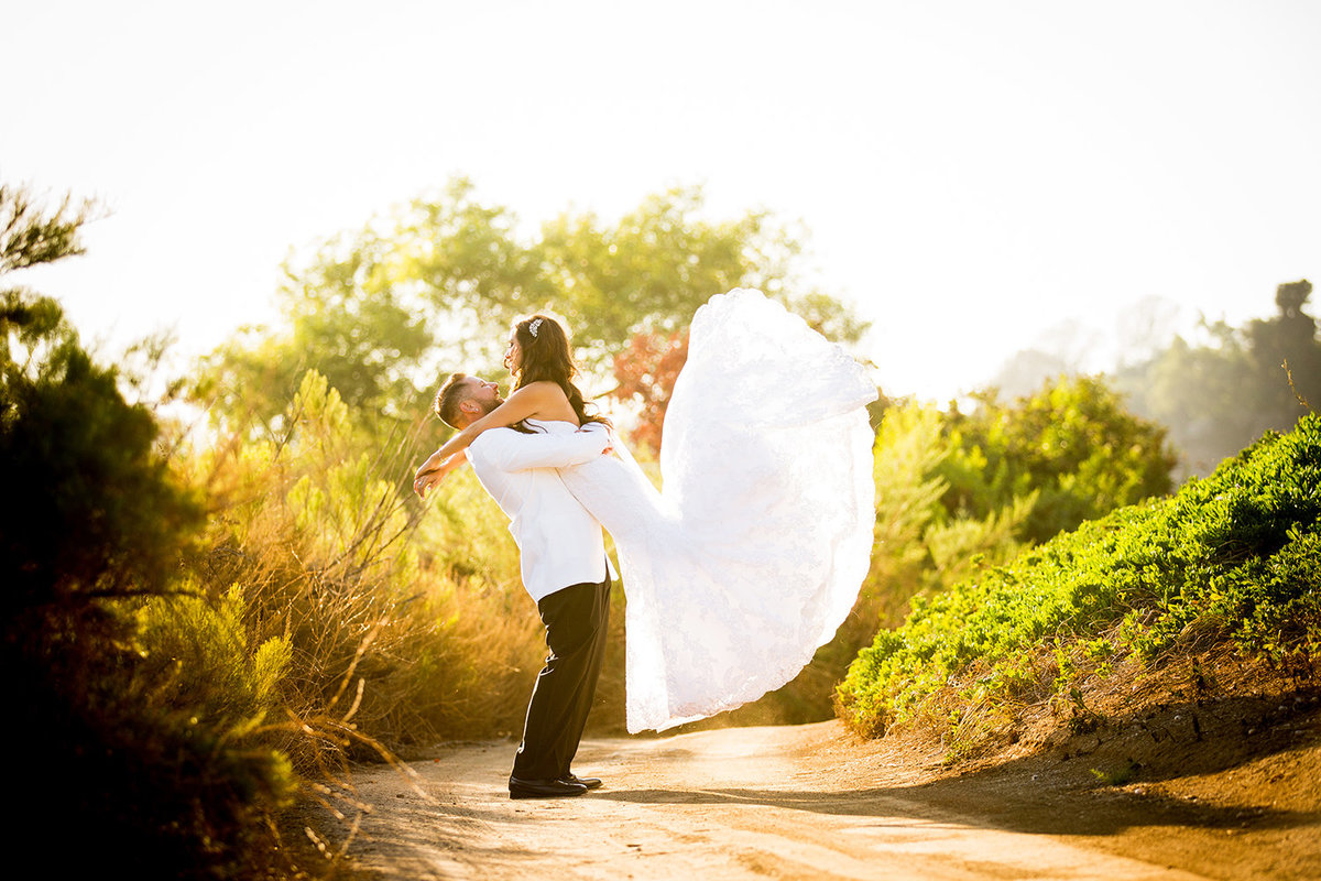 Steele Canyon wedding photos open field groom lifting bride