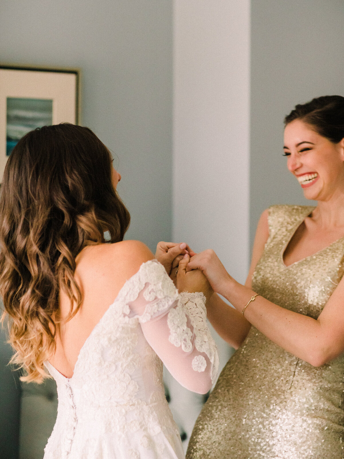 A candid moment between a bride and her best friend on the wedding day