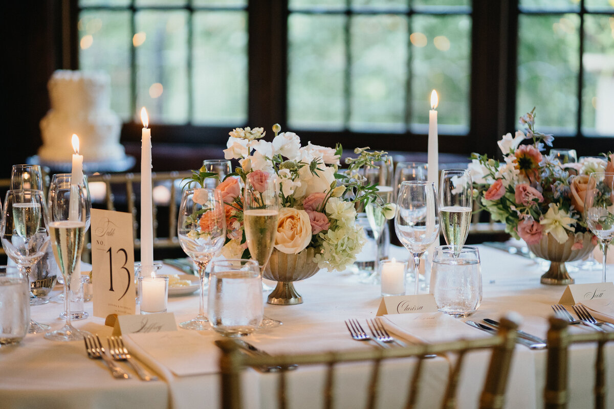 Colorful floral arrangements on a table cloth with candles