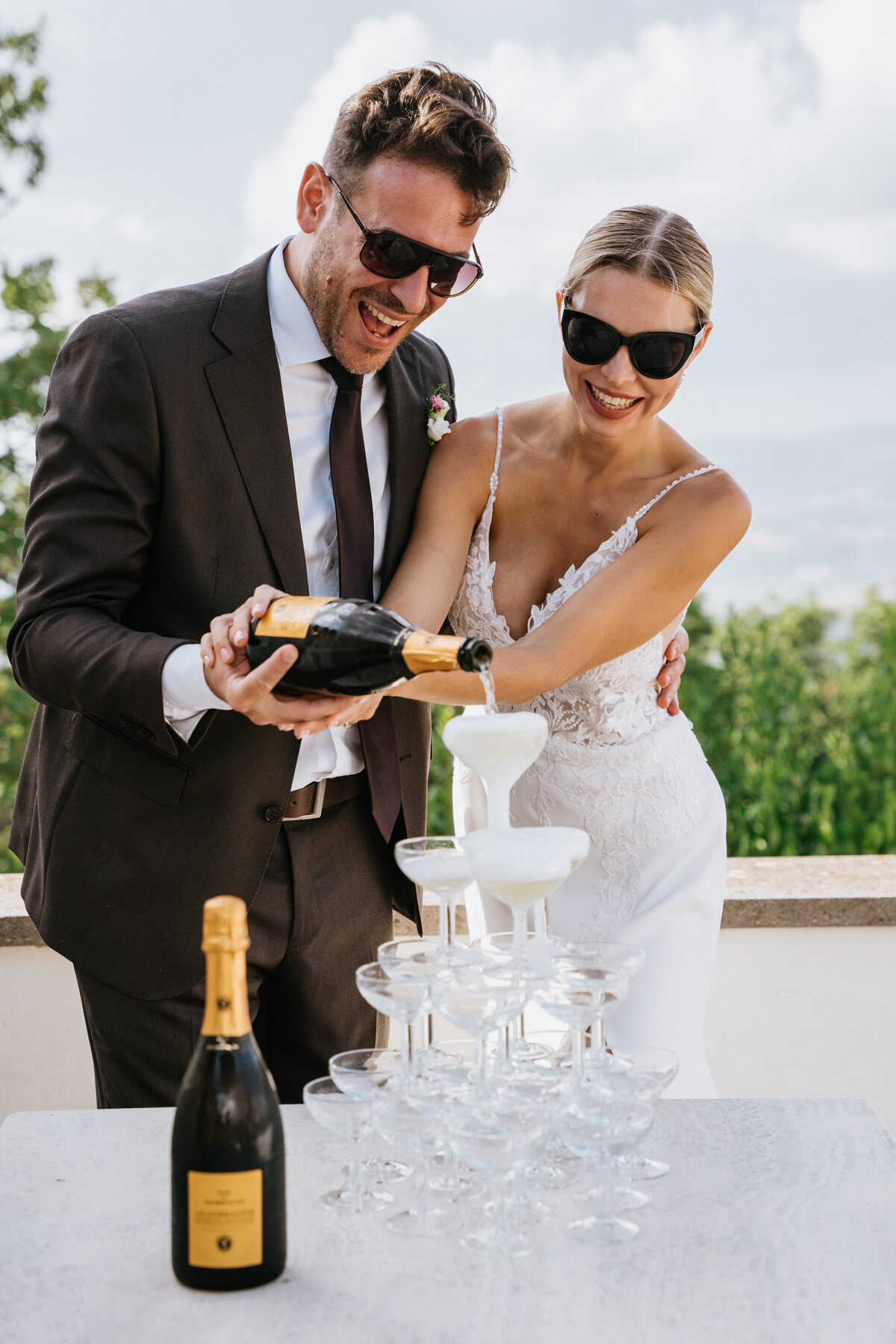 Couple pouring champange tower at their wedding in Tuscany