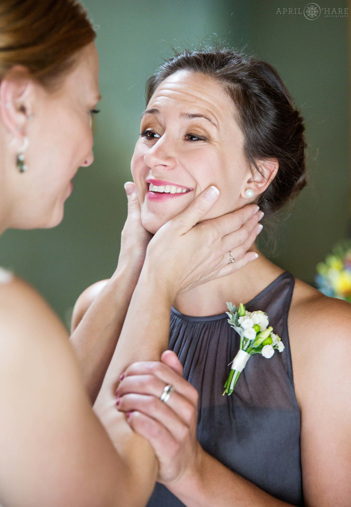 Bride has a sweet moment with her friend at her Colorado mountain wedding
