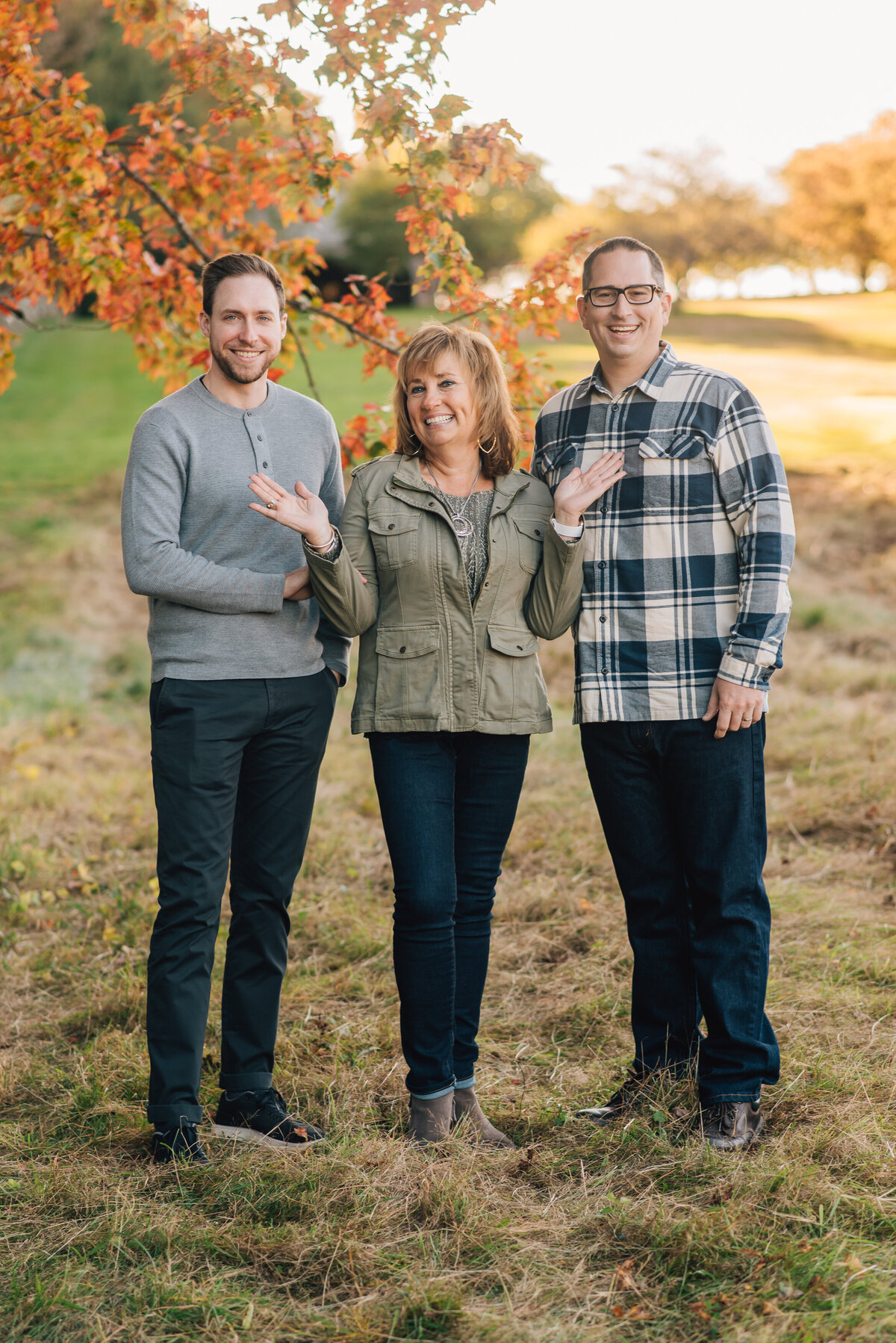 Grandma standing between sons at extended family session with Sharon Leger Photography