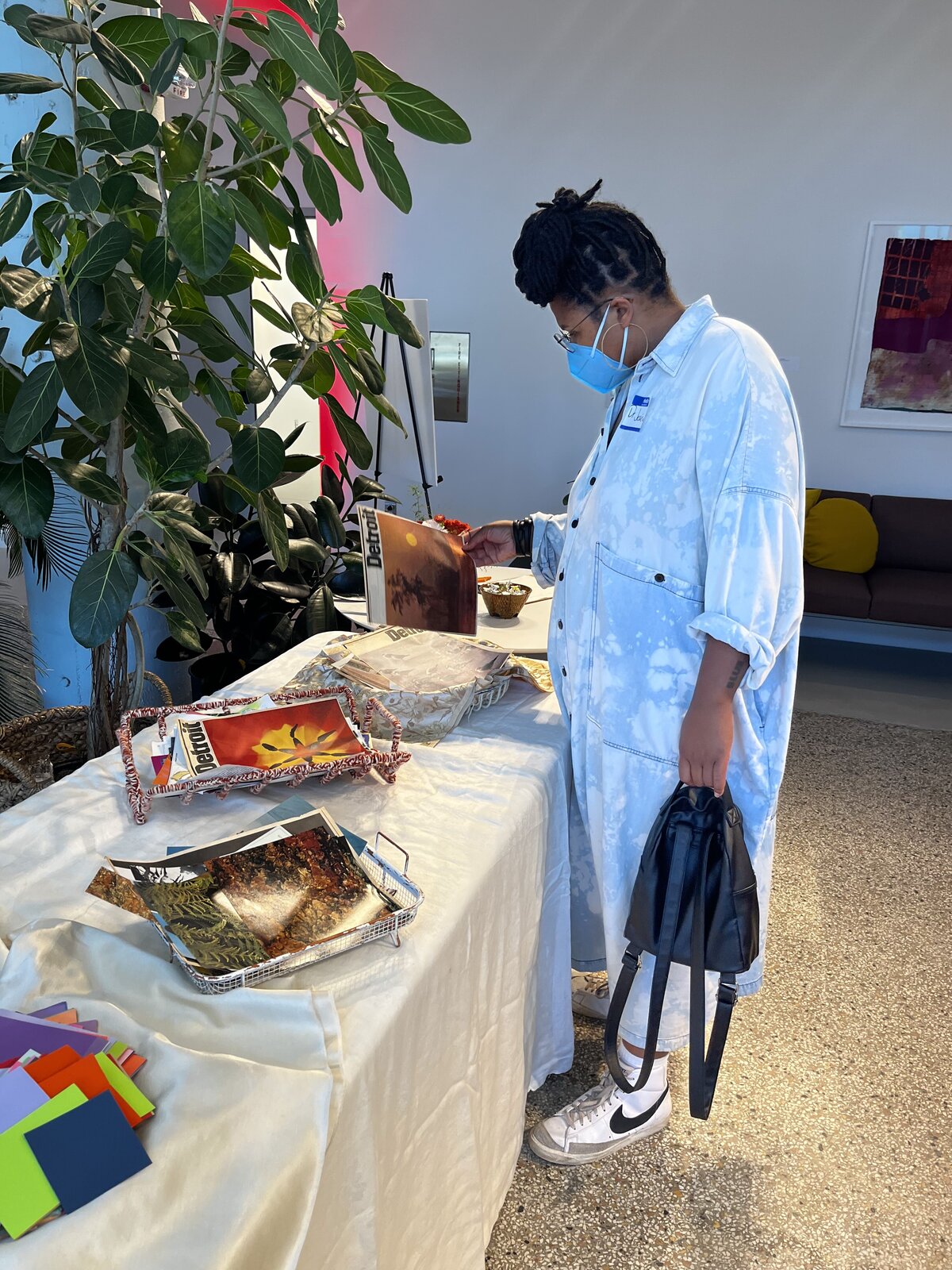 Person is looking through collage materials before the collage workshop by Nourish Events