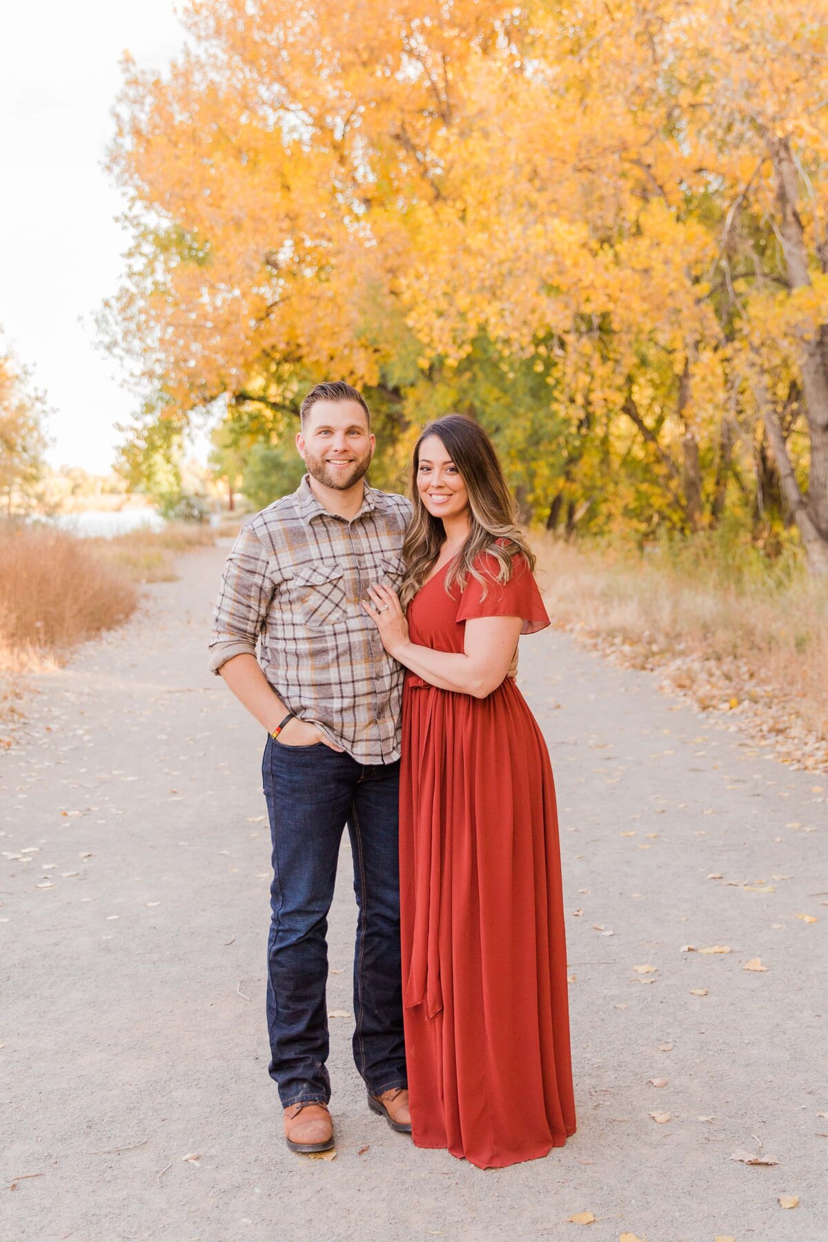 husband and wife standing for portrait in Erie, CO