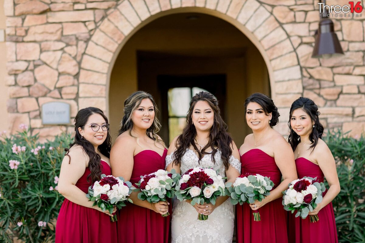 Bride poses with her Bridesmaids after the ceremony