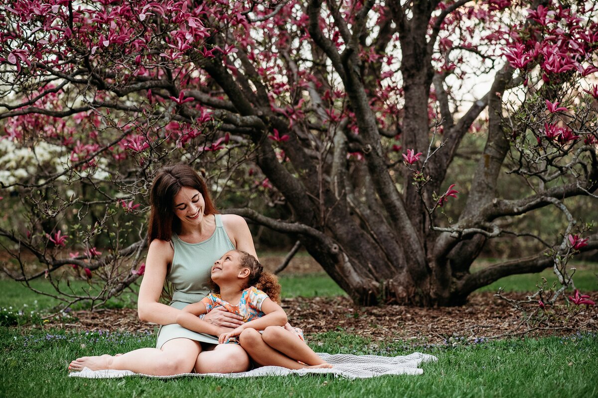 Mother and child cuddle magnolias McKennaPattersonPhotography