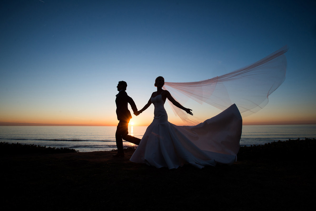 Married couple on beach during sunset
