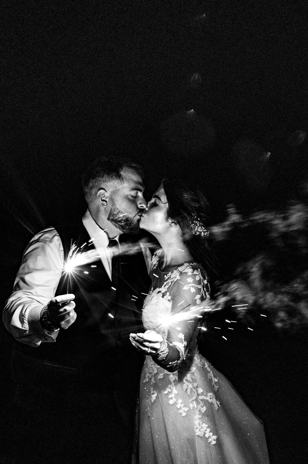 black and white portrait of bride and groom holding sparklers at chittenden vermont mountain top inn wedding