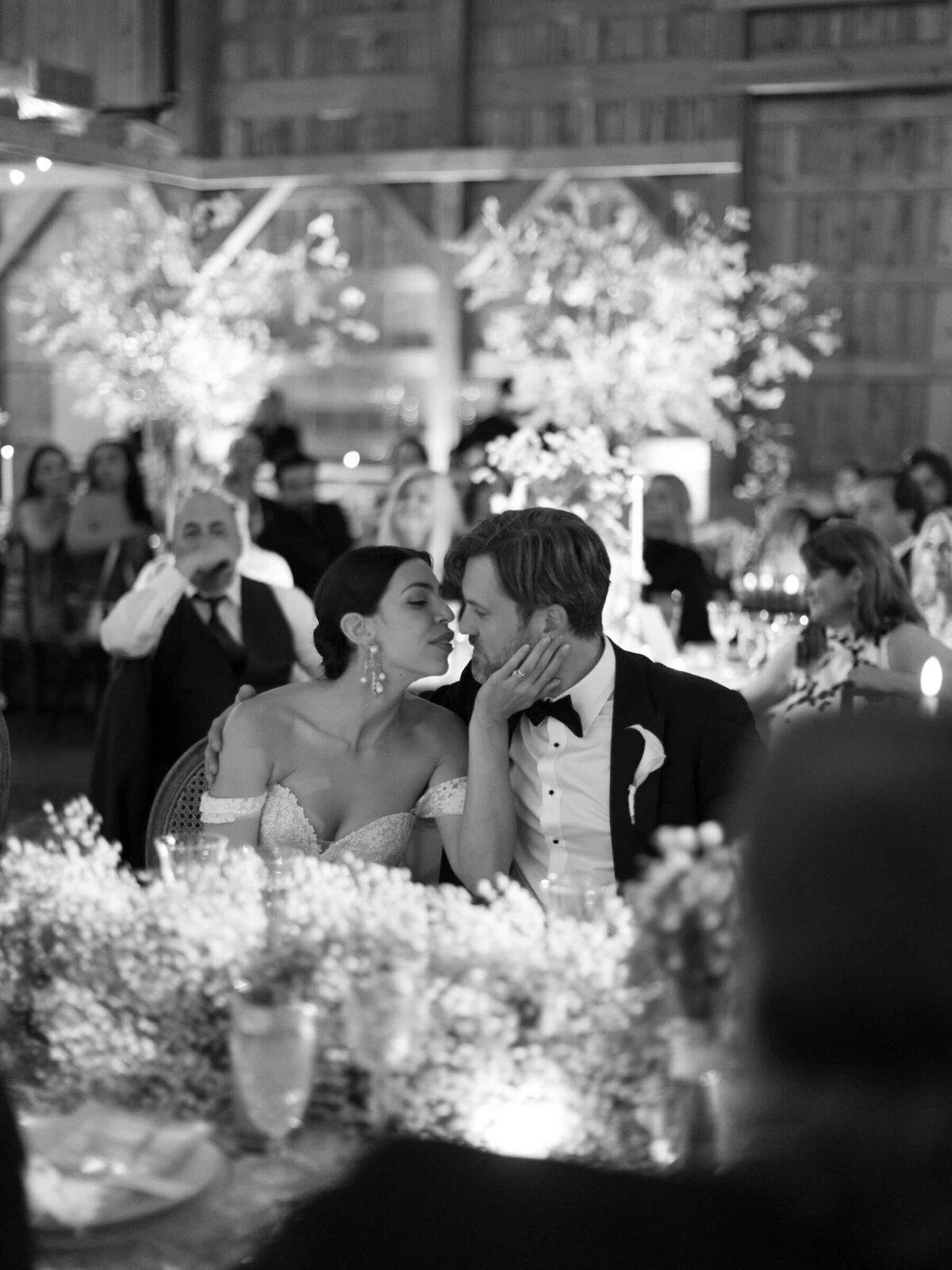 Bride and groom kissing black and white photography