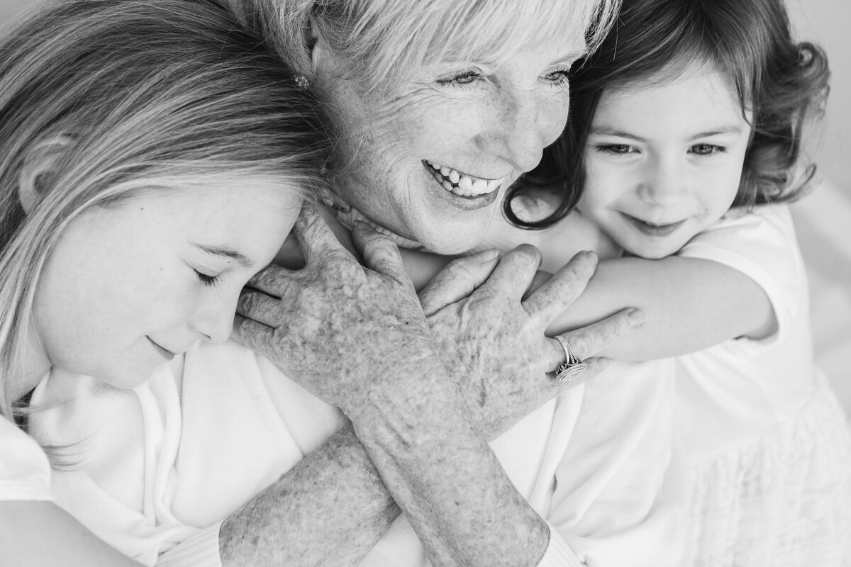 Two girls snuggle their grandma during a family photo session in Lexington KY.