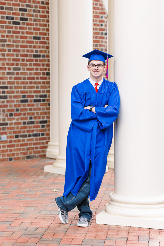 High School Senior Cap & Gown photography session in front of school building in Wake Forest, NC