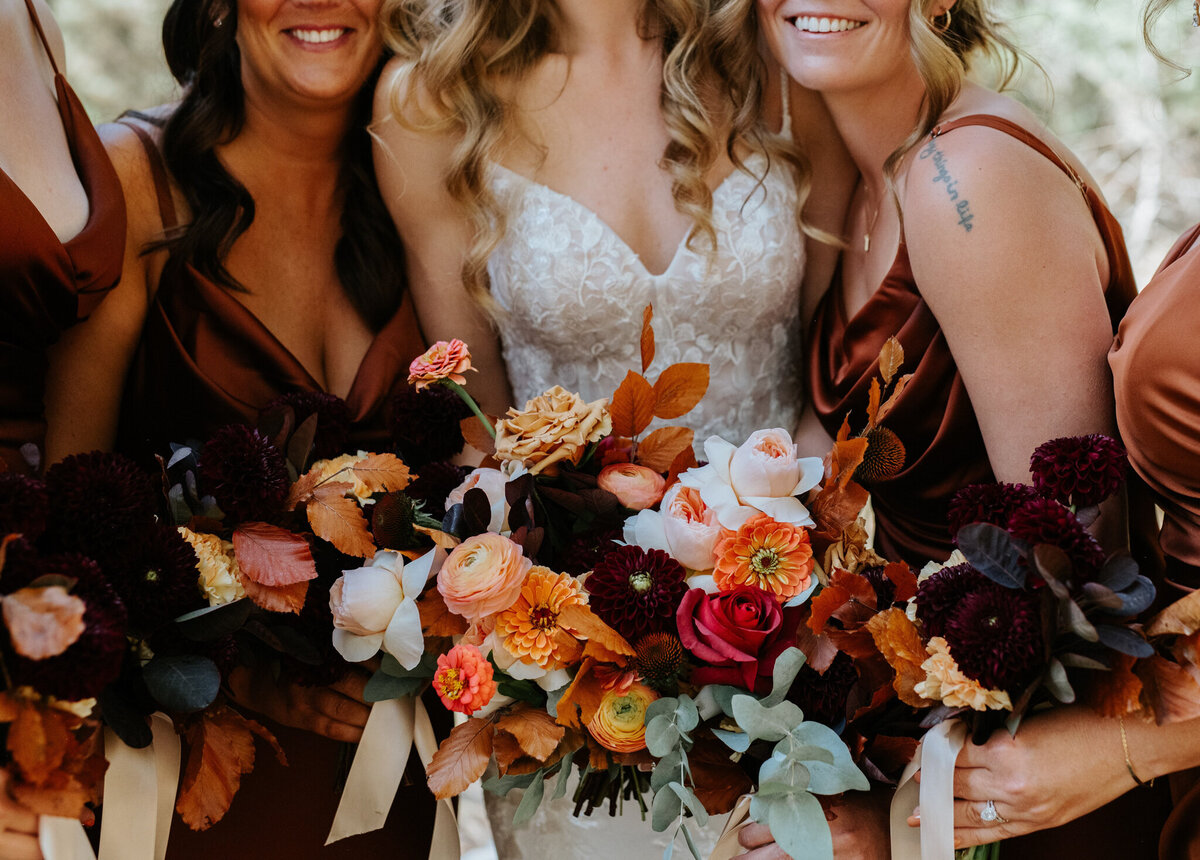 Burgundy, rust and tangerine, fall-inspired bridal bouquet by The Romantiks, romantic wedding florals based in Calgary, AB & Cranbrook, BC. Featured on the Brontë Bride Vendor Guide.