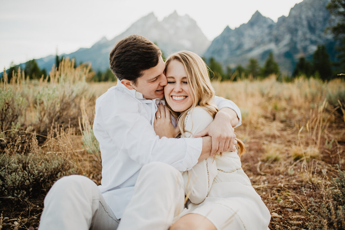 Photographers Jackson Hole capture man hugging woman and making her laugh