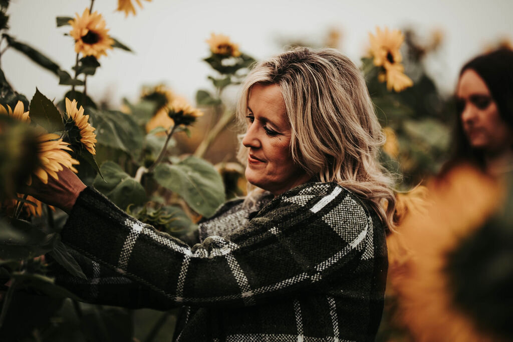 lady by sunflowers