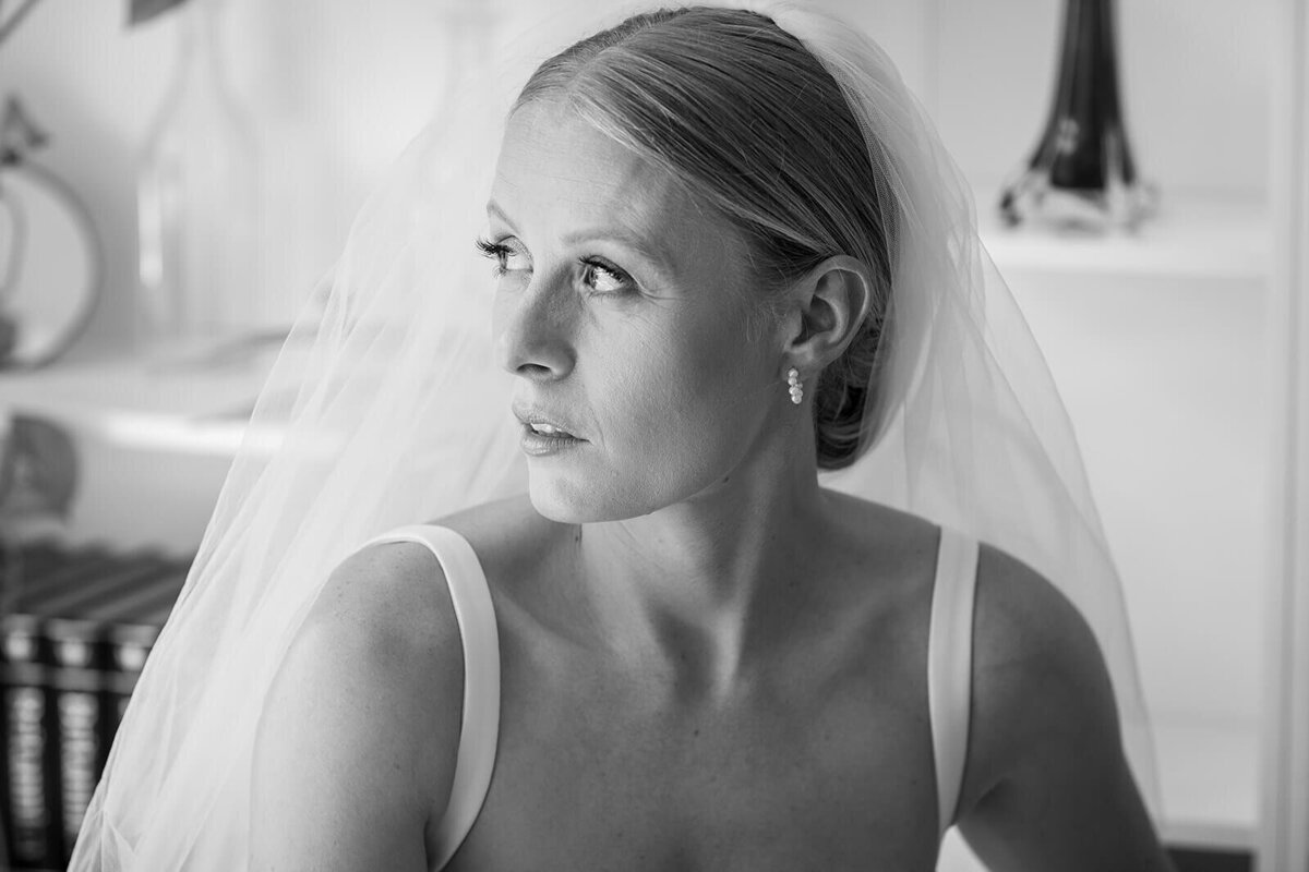 Bride in london home looking out window