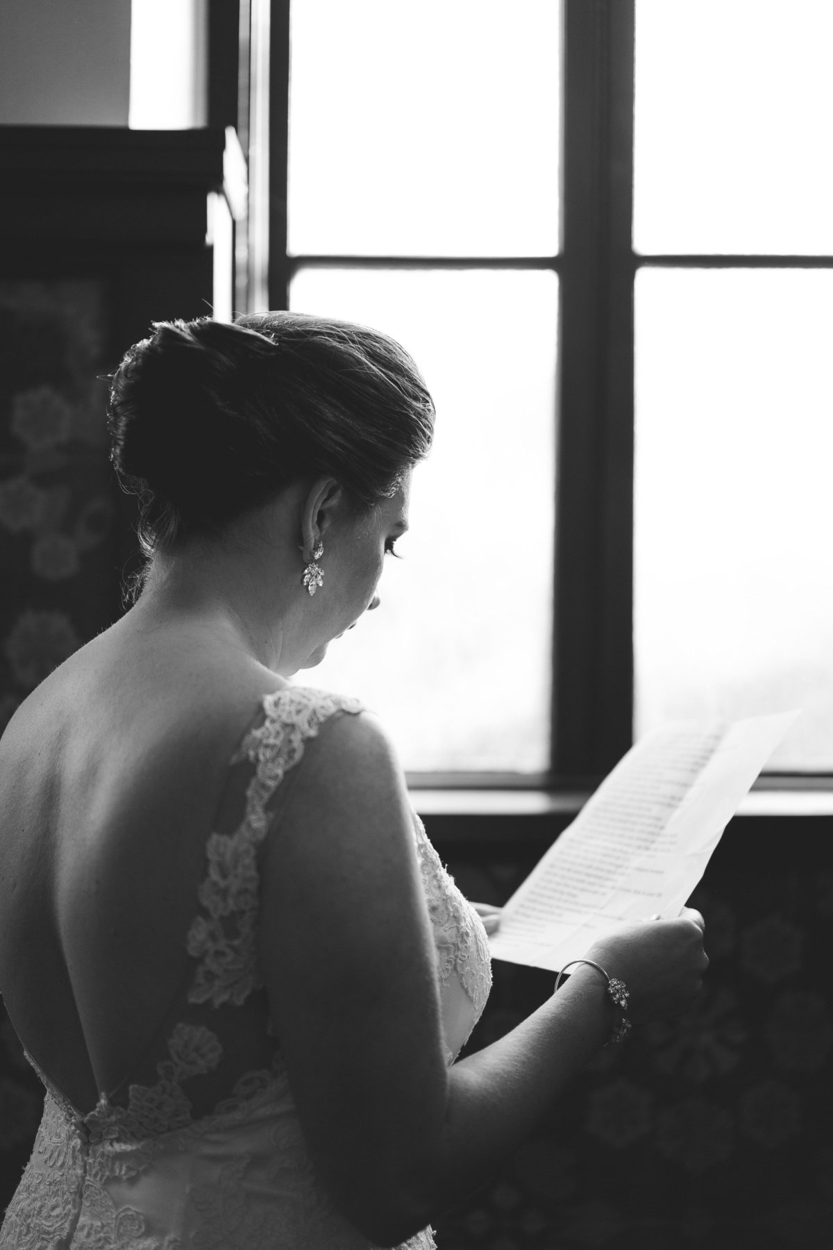 Bride reading over her wedding vows before wedding ceremony at Hotel Emma in downtown San Antonio