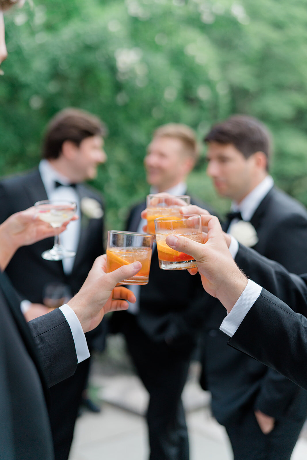 Cocktail hour at the Bradley Estate. Groomsmen grab old fashioneds and toast to the bride and groom.