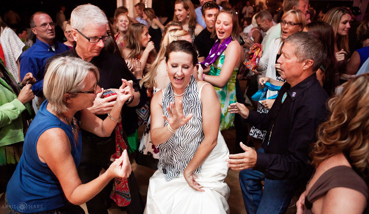Bride parties on the dance floor surrounded by her guests in Steamboat Springs CO