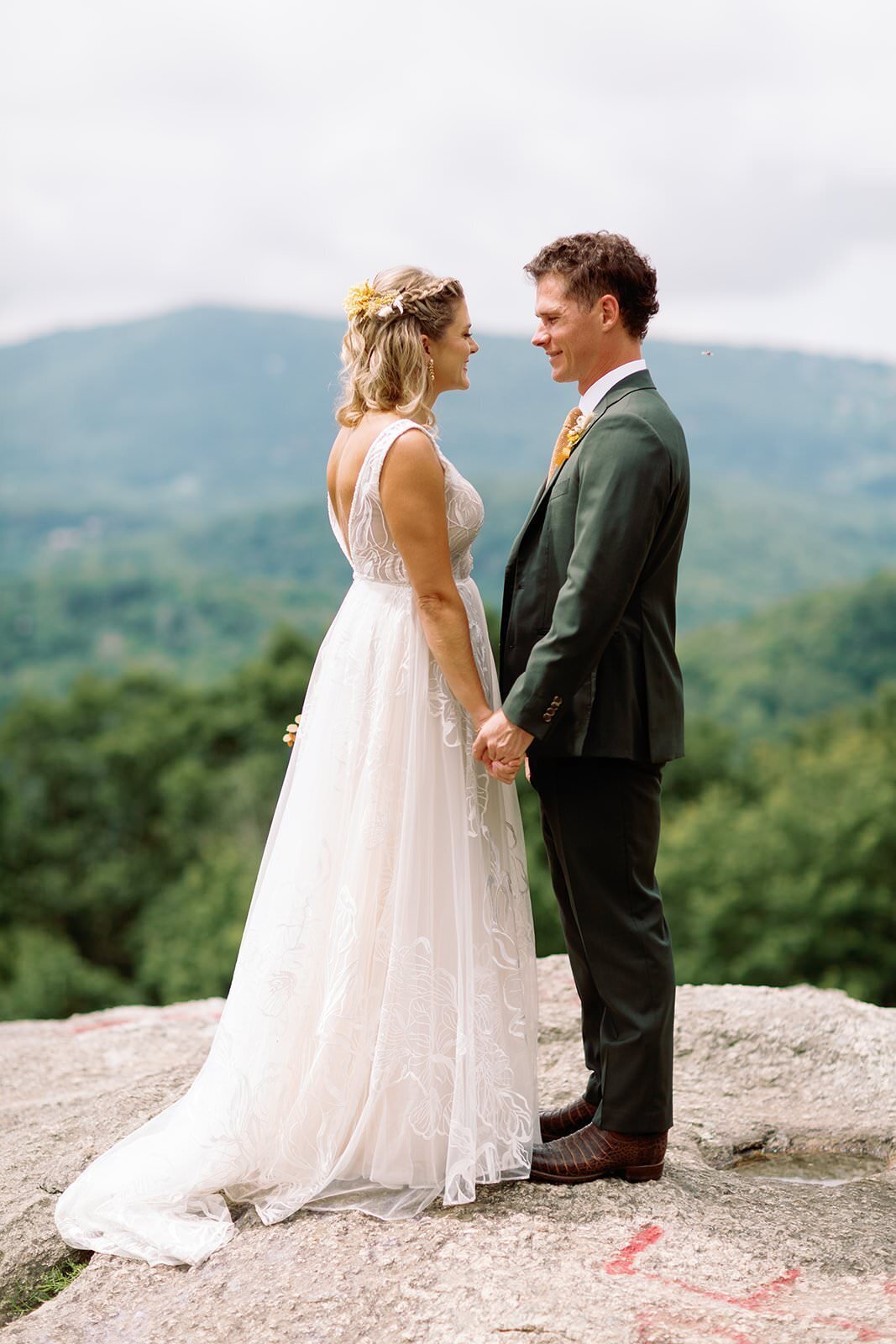 Bride and groom stand together on top of North Carolina mountaintop