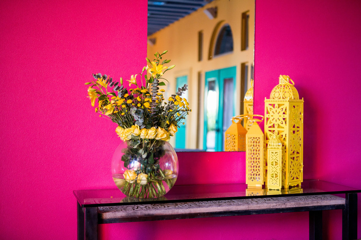 wedding reception decor floral and colored lanterns bold pink and yellow modern spanish fiesta themed at Casa Mariposa