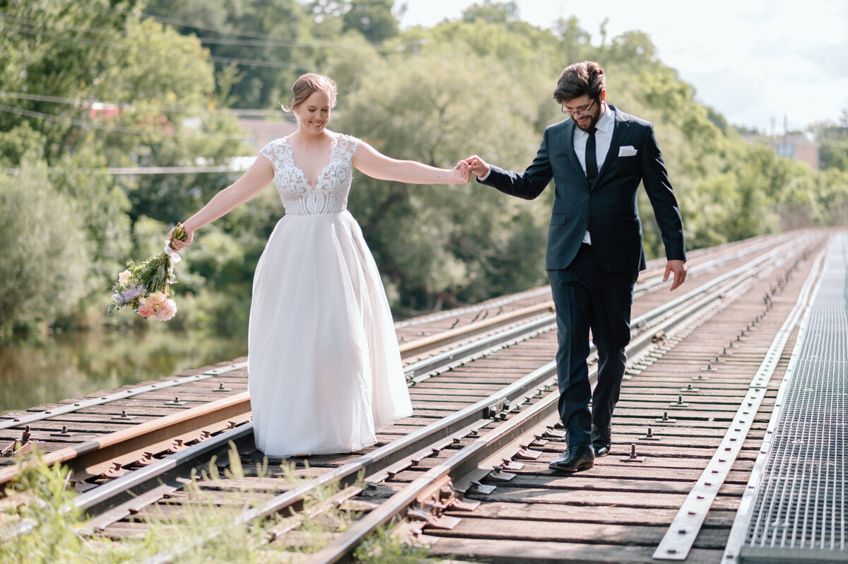 couple walks on the train tracks