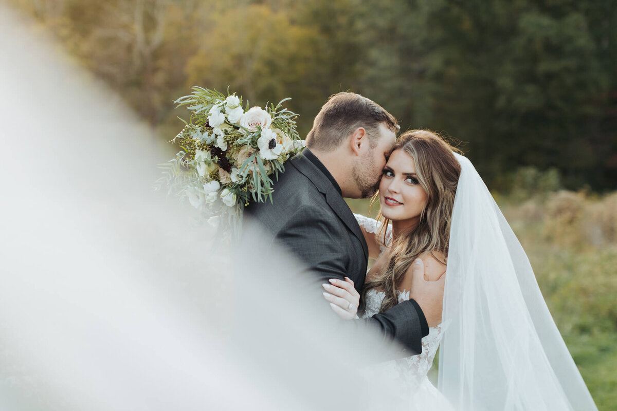 Shannan and Alex Wedding - groom kissing bride on cheek