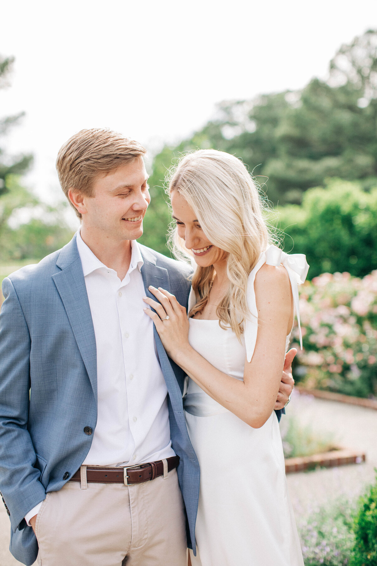 Engagement portrait of the bride and groom laughing in a rose garden in Memphis, Tennessee