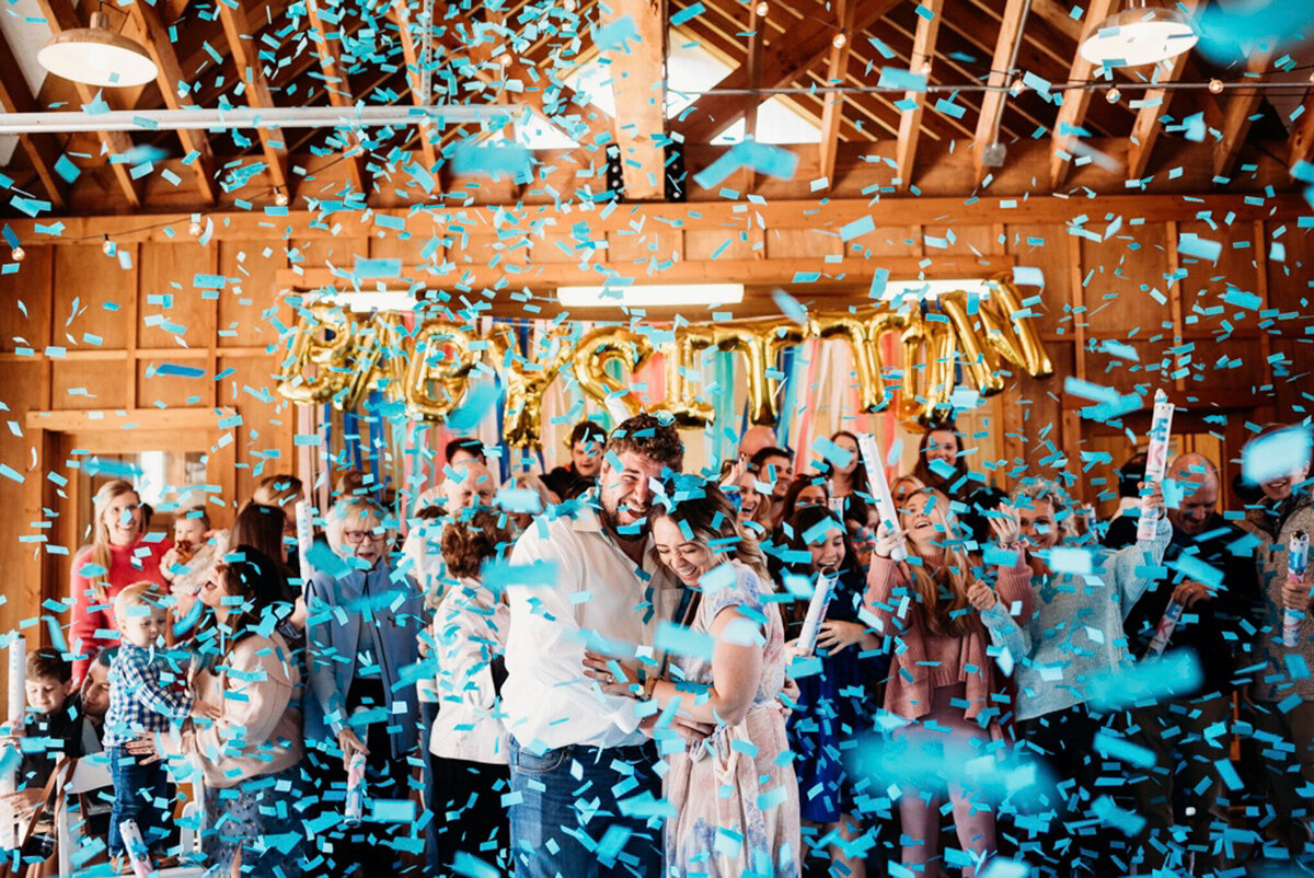 photo of couple surrounded by blue confetti