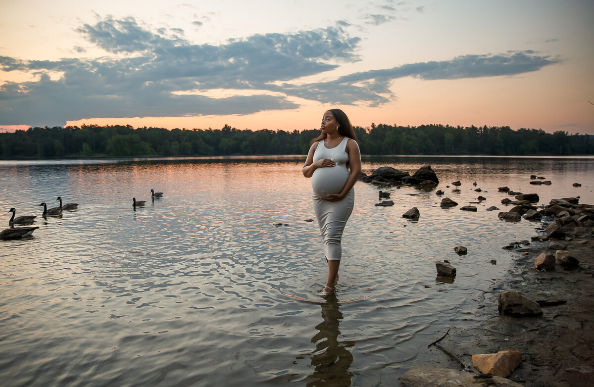 A pregnant mother poses for her maternity photoshoot in a Baltimore lake.