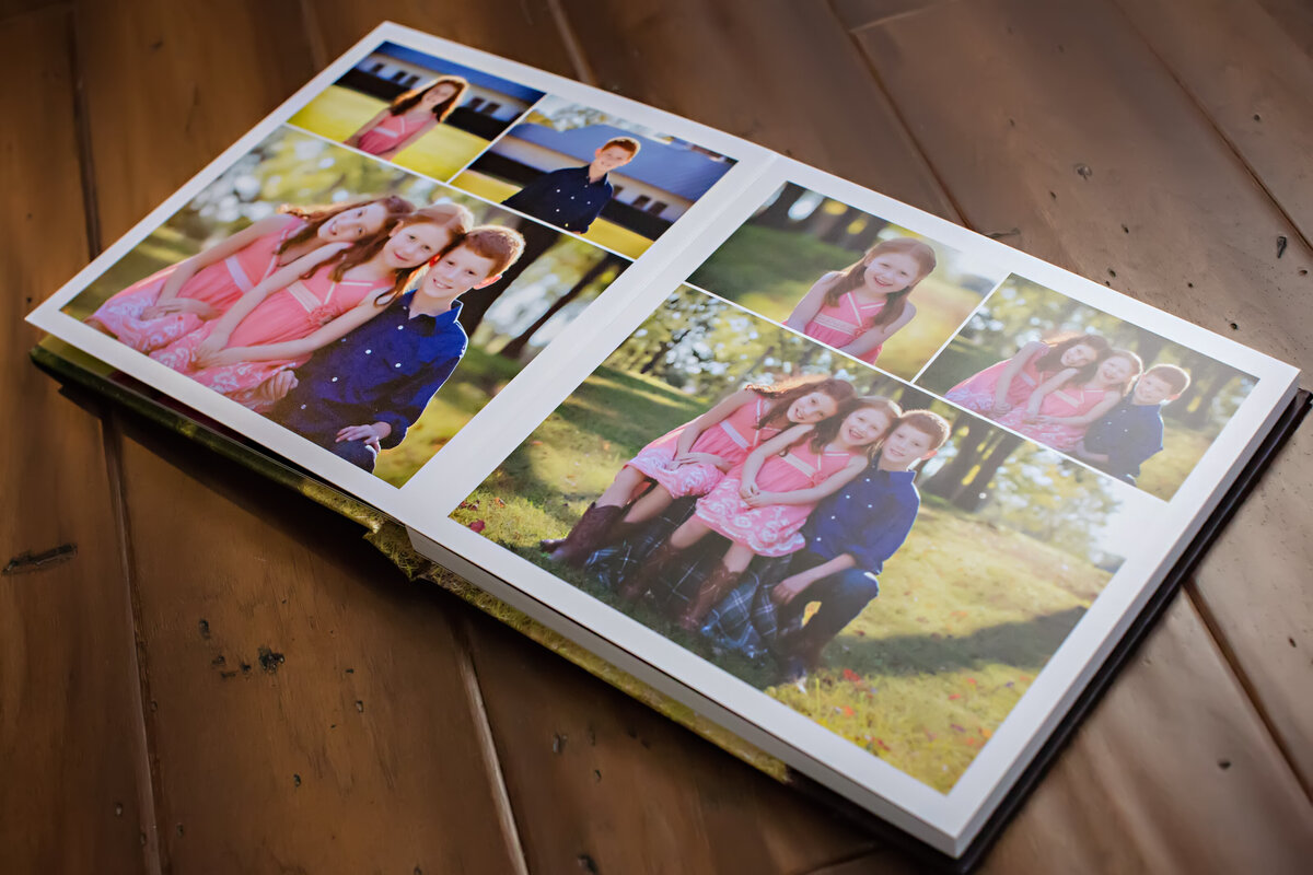 Photo Cover Session Book opened to a custom two-page spread from a spring family portrait session featuring three children, shown in a lay-flat design that highlights seamless printing and storytelling layout.